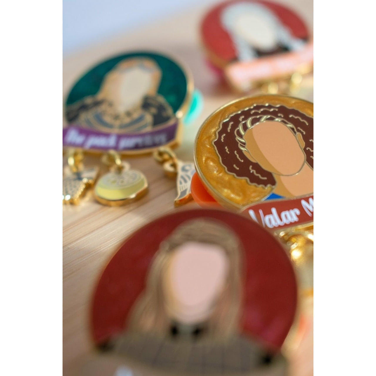 The image shows a close up of some Women of Westeros pins with the Missandei pin in focus.