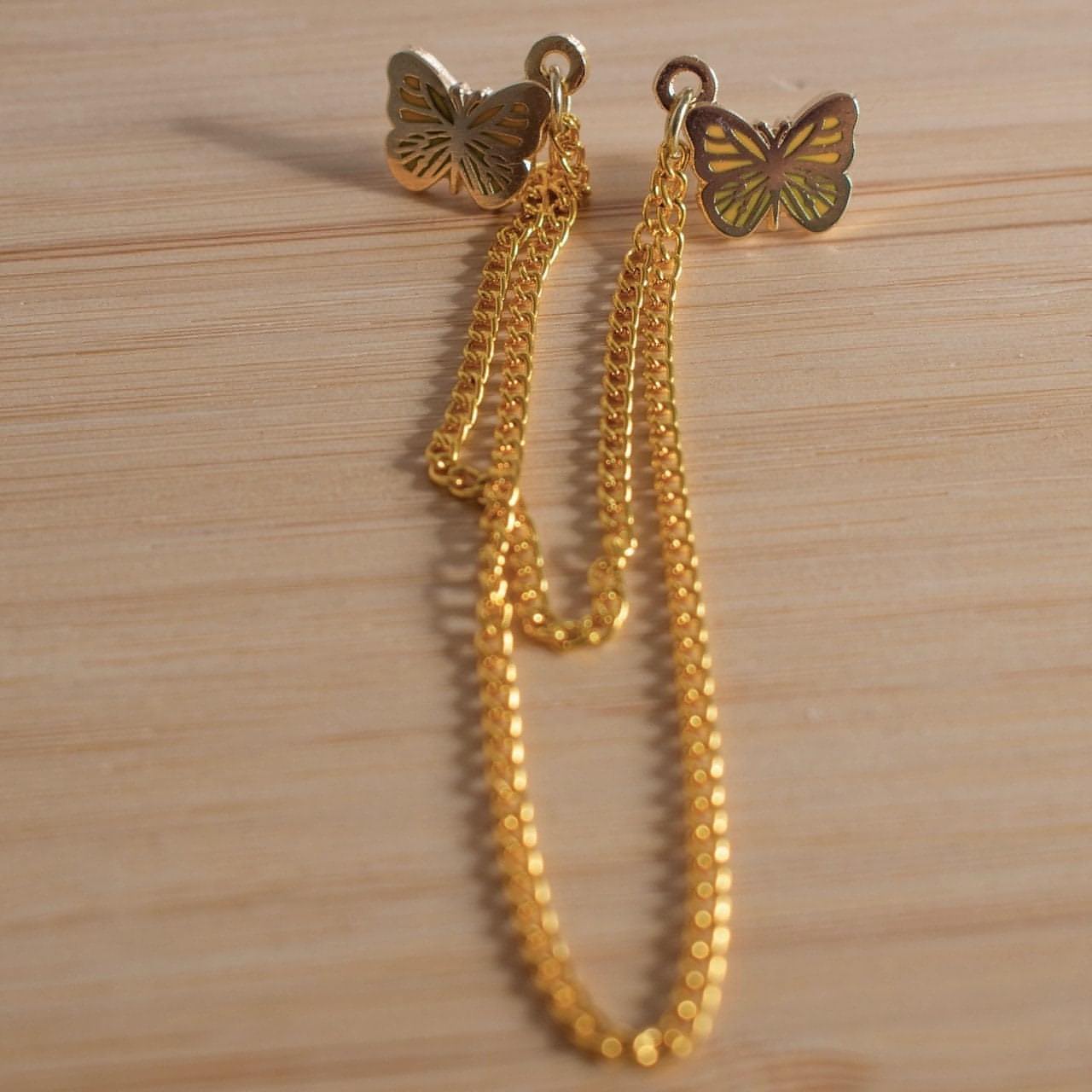 A wider shot of the butterfly pins show the length of the chains.