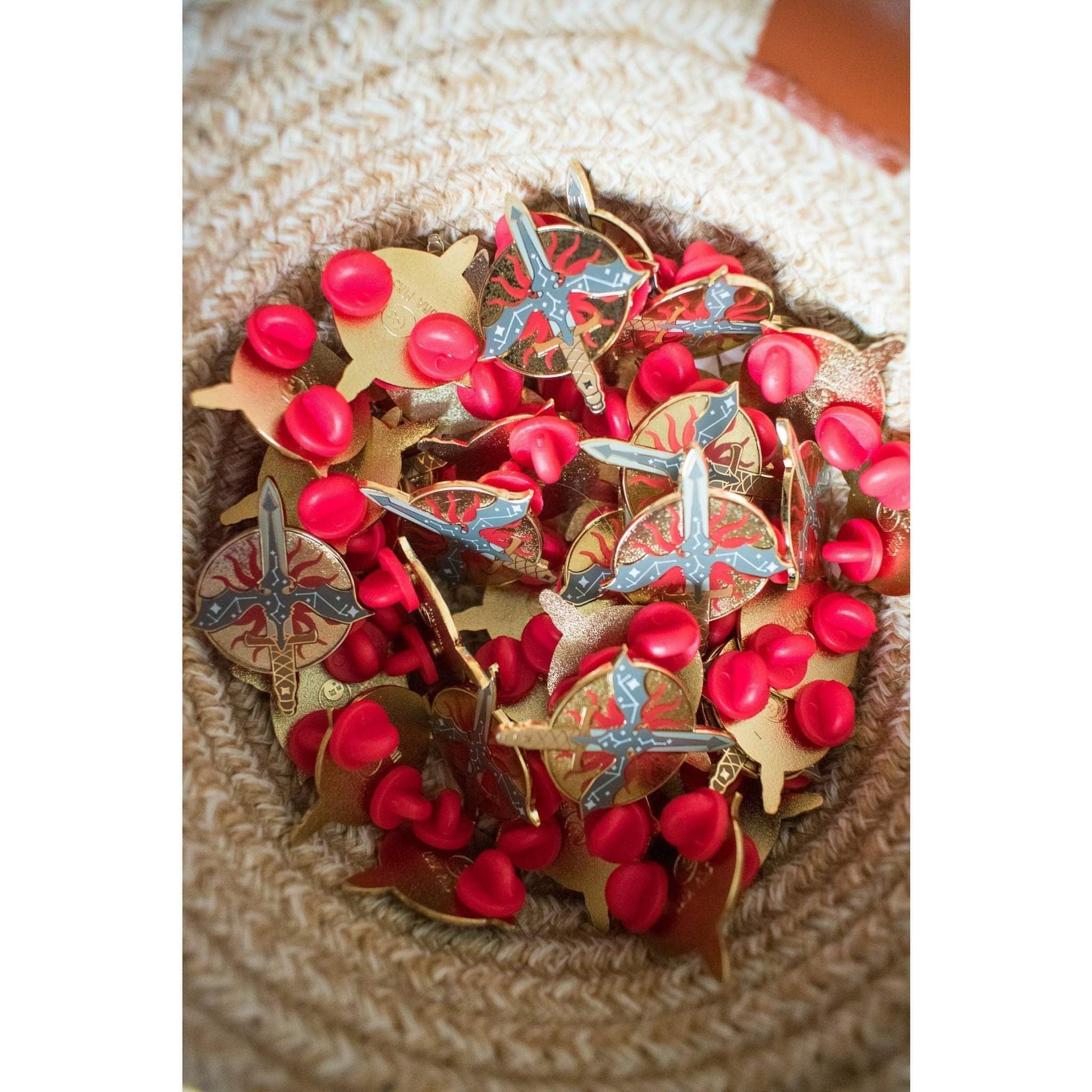 A basket full of Inquisition pins shows that they each come with two red rubber clutches.